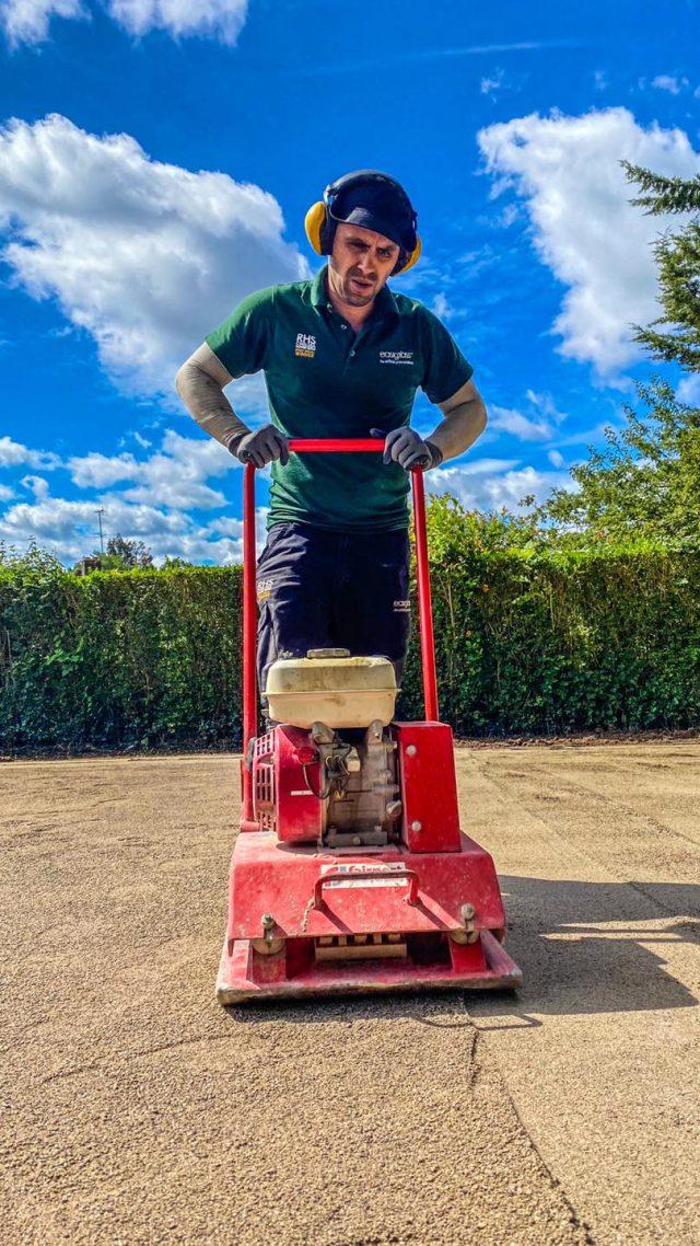 Easigrass employee flattening out the ground.