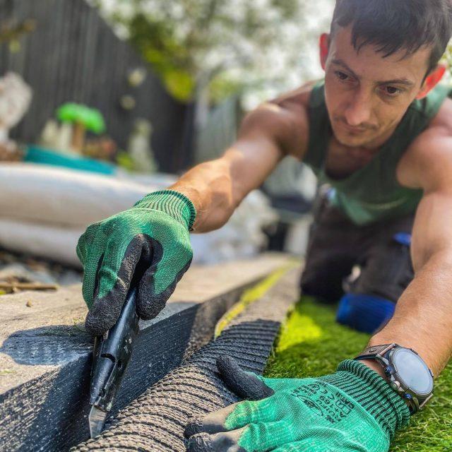 Easigrass worker cutting grass.